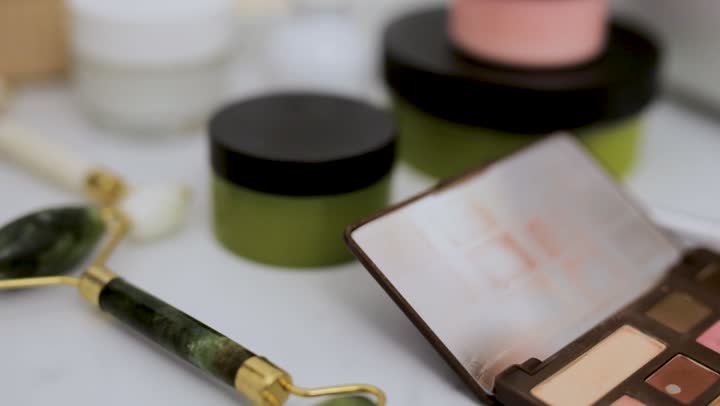 Skincare serum on a pale stone pedestal